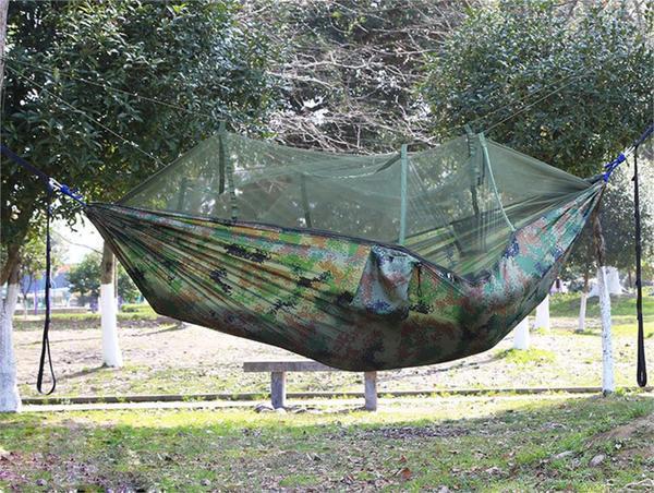 enjoy swinging without being seen in this camouflage mosquito net covered hammoc